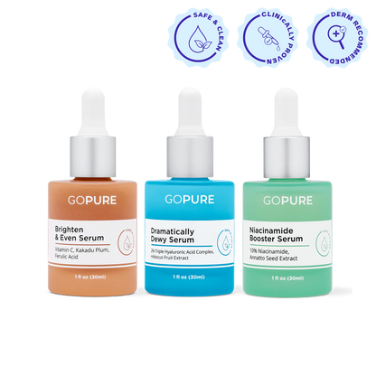 Three colorful goPure serum bottles with droppers shown side by side against a white background. From left to right: Brighten & Even Serum (orange, 1 fl oz/30 mL), Dramatically Dewy Serum (blue, 1 fl oz/30 mL), and Niacinamide Booster Serum (green, 1 fl oz/30 mL). Above them are three icons labeled Safe & Clean, Clinically Proven, and Derm Recommended.