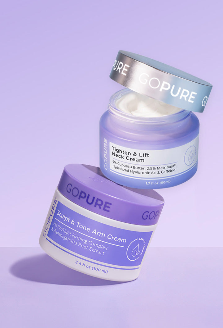 
Two skincare product jars from the brand "GOPURE" on a lavender background. The upper jar is labeled "Tighten & Lift Neck Cream" with a metallic lid slightly open, showing white cream inside. The lower jar is labeled "Sculpt & Tone Arm Cream" with a purple lid and white container. Both feature clean, modern packaging.