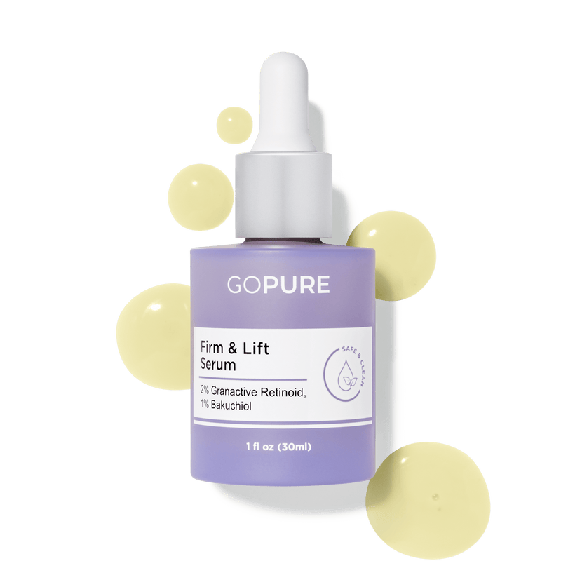 Purple bottle of GoPure Firm & Lift Serum with visible serum droplets, containing 2% Granactive Retinoid and 1% Bakuchiol. 1 fl oz