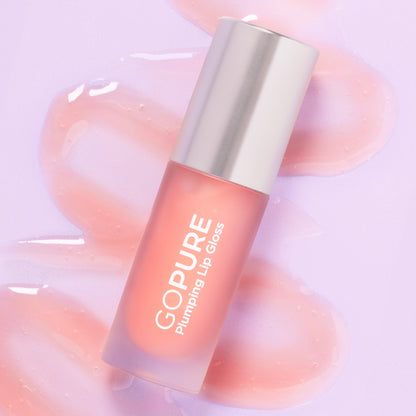 A GoPure Plumping Lip Gloss bottle on a lavender background, surrounded by glossy, peach-toned lip gloss smears. The product is labeled “GOPURE Plumping Lip Gloss.”